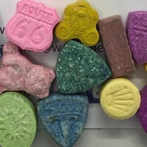 A hand holding MDPV powder with a UK and EU flag, symbolizing online purchase options